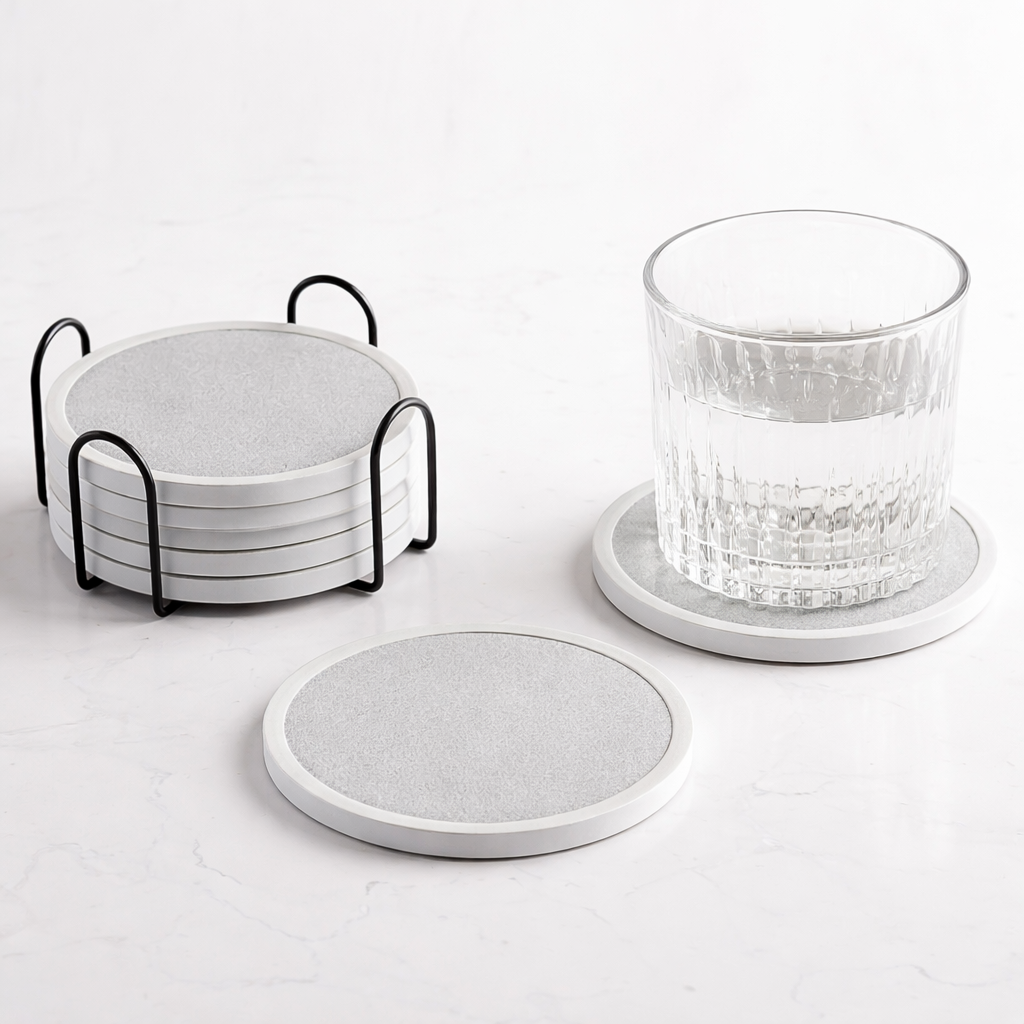 Decorative light grey coasters styled with a glass on a modern tabletop