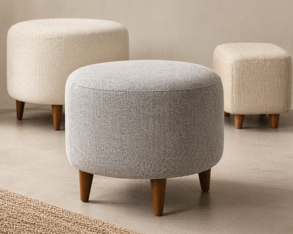 Light grey upholstered ottoman pouffes with wooden legs for stylish and versatile seating